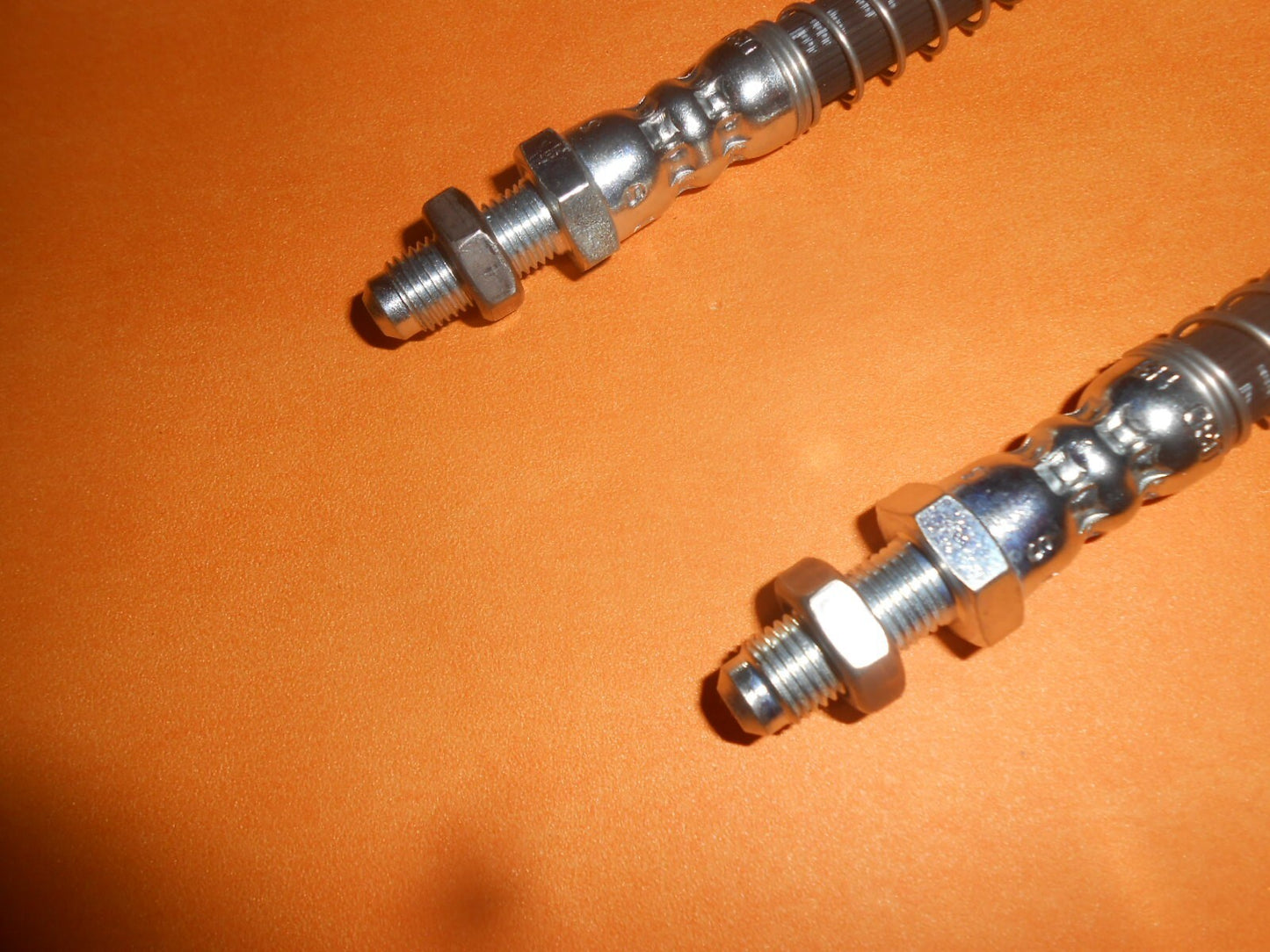 TRIUMPH TR4A (1965-1967) FRONT ARMOURED BRAKE HOSES PAIR + locking nuts